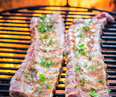 Hot ribs with thyme and spices on grill